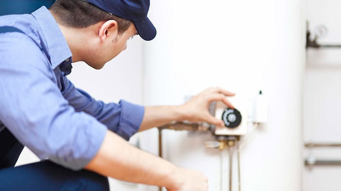Plumber repairing an hot-water heater Plumber repairing an hot water heater
