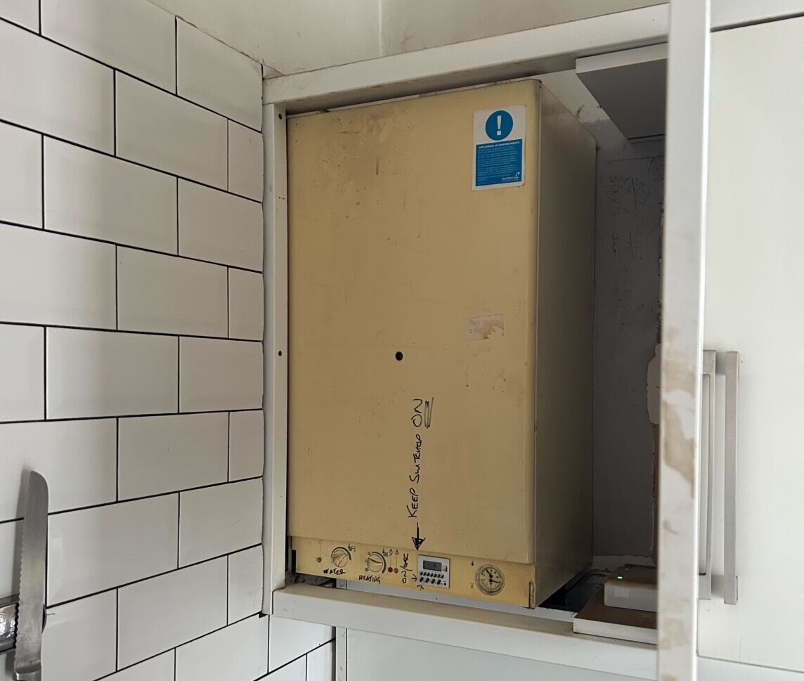 IMG_7043 old boiler in a modern white kitchen cabinet